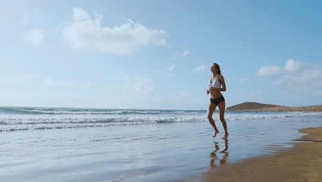 Running-woman,-female-runner-jogging-during-outdoor-workout-on-beach.,-fitness-model-outdoors.